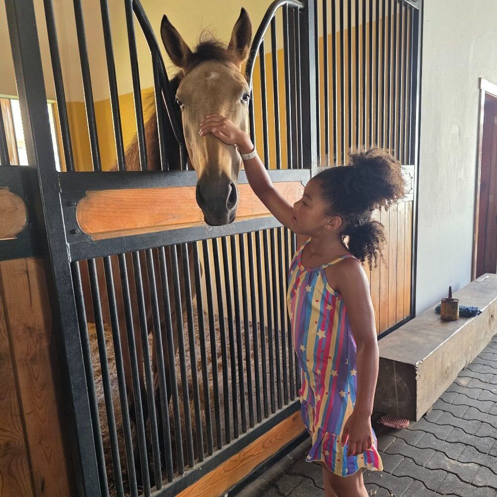 Child with horse at Los Establos Equestrian Center, Cap Cana
